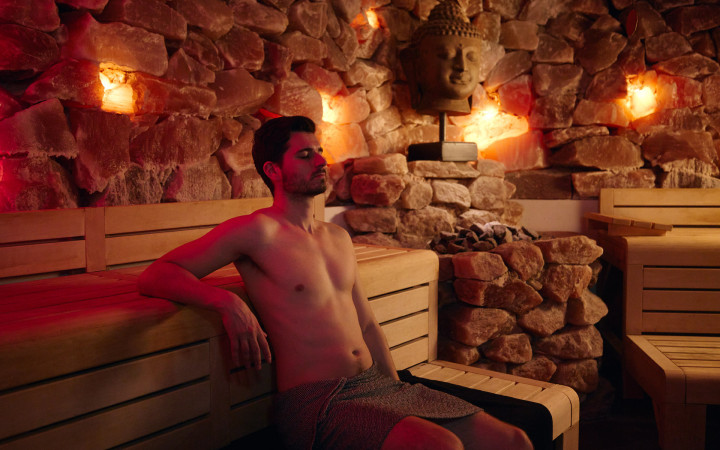 Een meneer zit in de himalaya sauna